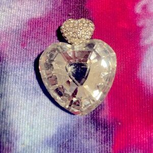 Large Silver tone heart pendant with a small clear rhinestones heart on top.